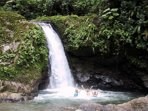 Waterfall jumping adventure in tropical river